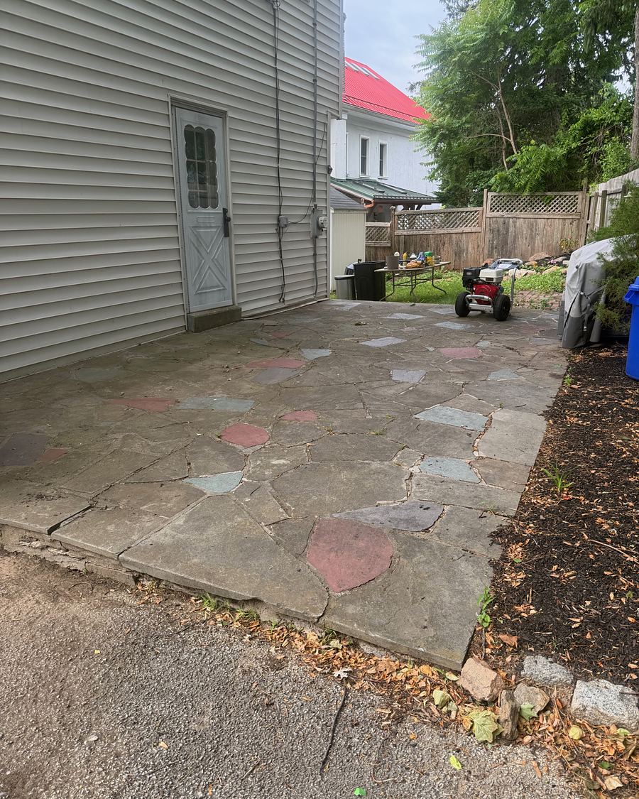 Irregular flagstone patio in Havertown, PA before washing, the stone a dull gray-brown with the colors hidden