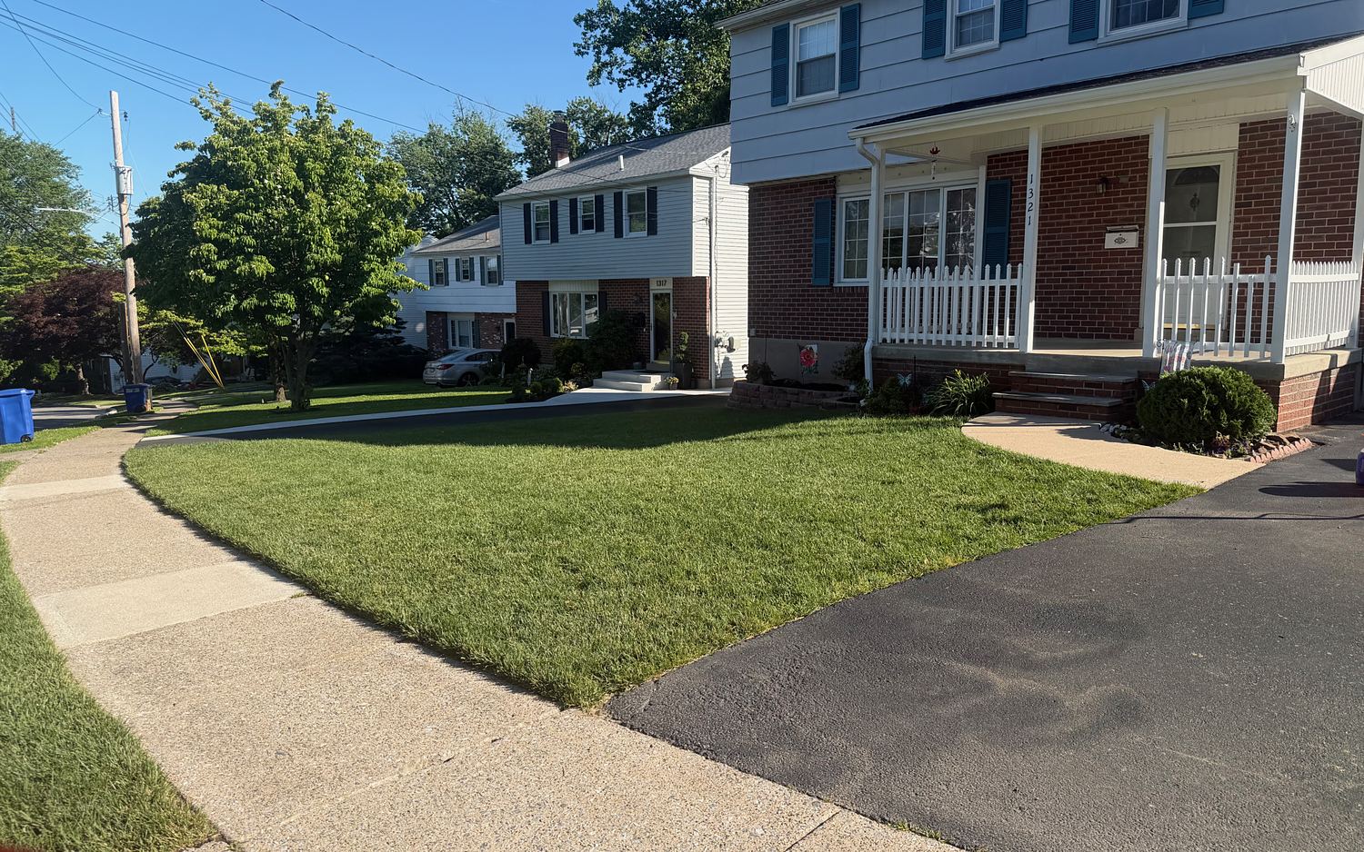 The same Havertown, PA front walkway after pressure washing, an even pale cream concrete