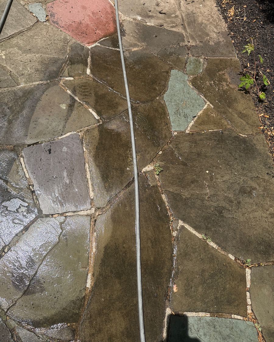Flagstone path in Havertown, PA mid-wash, cleaned stone on one side and grimy stone on the other