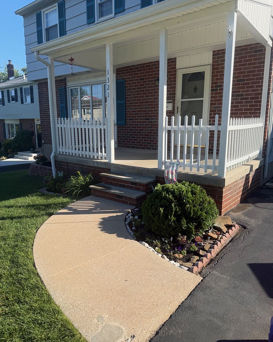 Bright clean concrete walkway meeting the brick front steps of a Havertown, PA porch