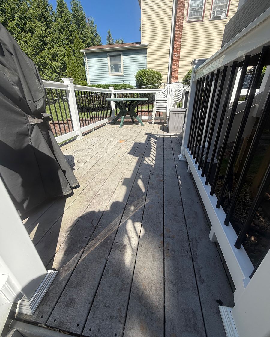 Composite deck in Havertown, PA before washing, the boards dark and blotchy with grime