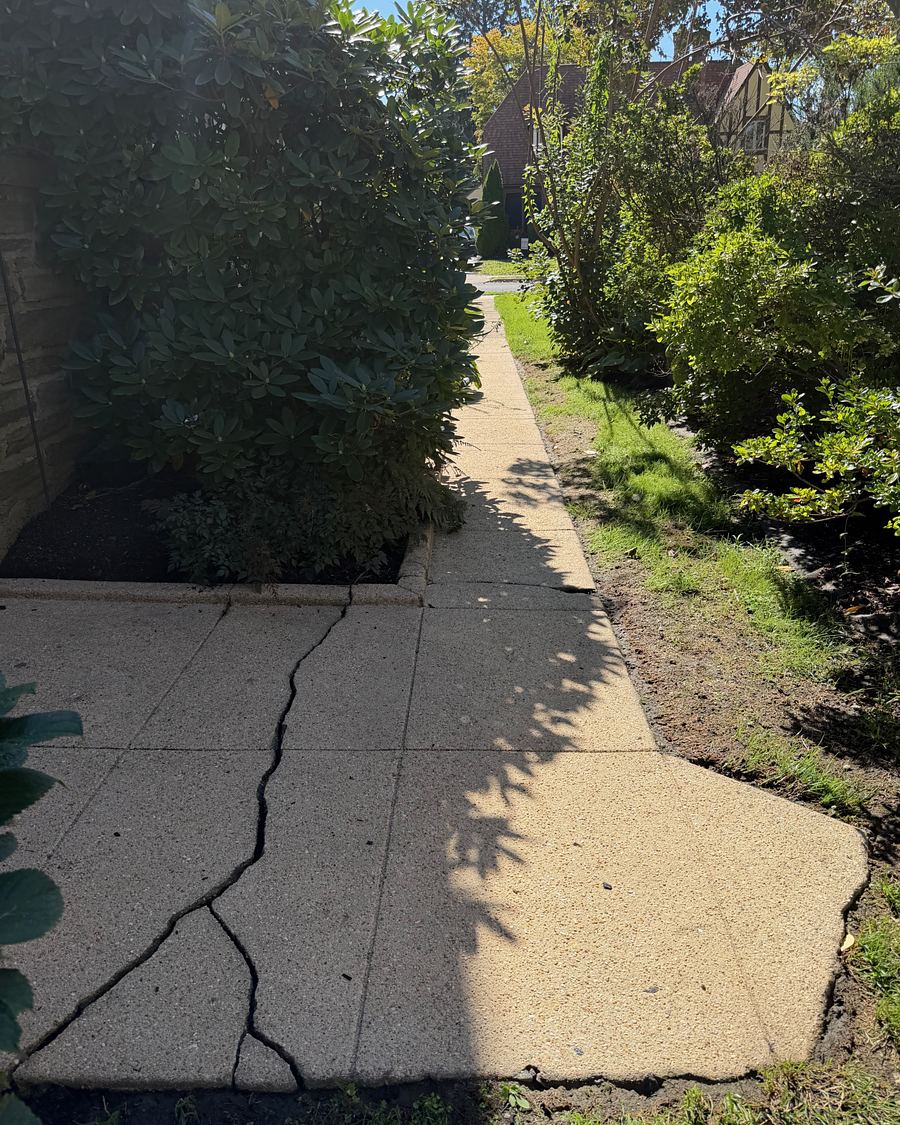 The same cracked Drexel Hill, PA side walkway after pressure washing, the concrete a clean warm tan