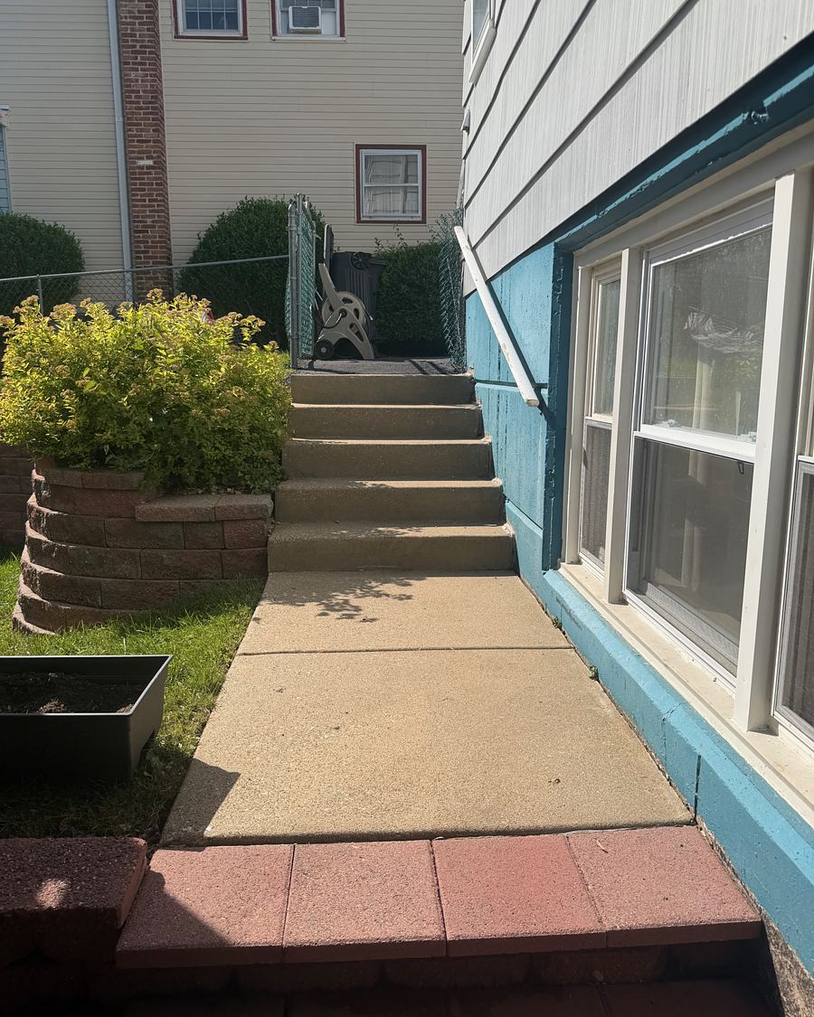 The same Havertown, PA side walkway and steps after pressure washing, the concrete pale and even