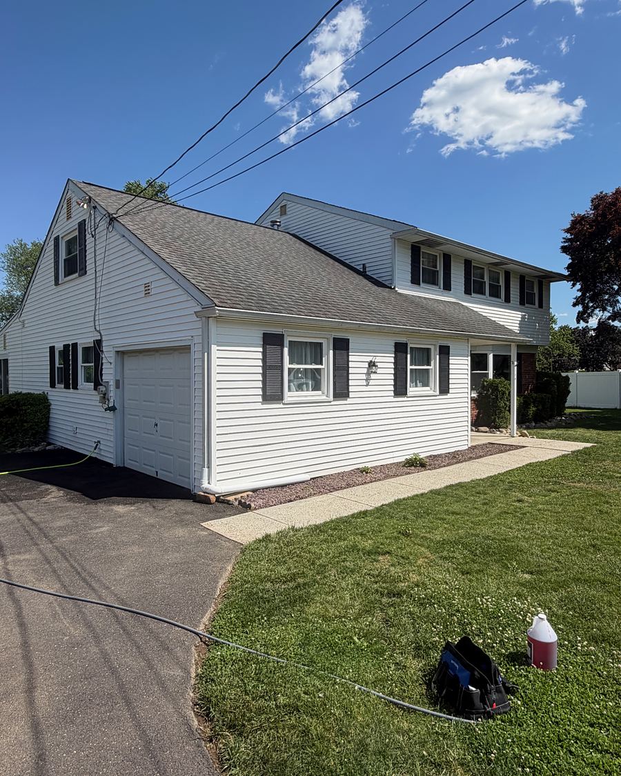 Clean concrete walkway leading across a lawn to a freshly washed white home in Hatboro, PA