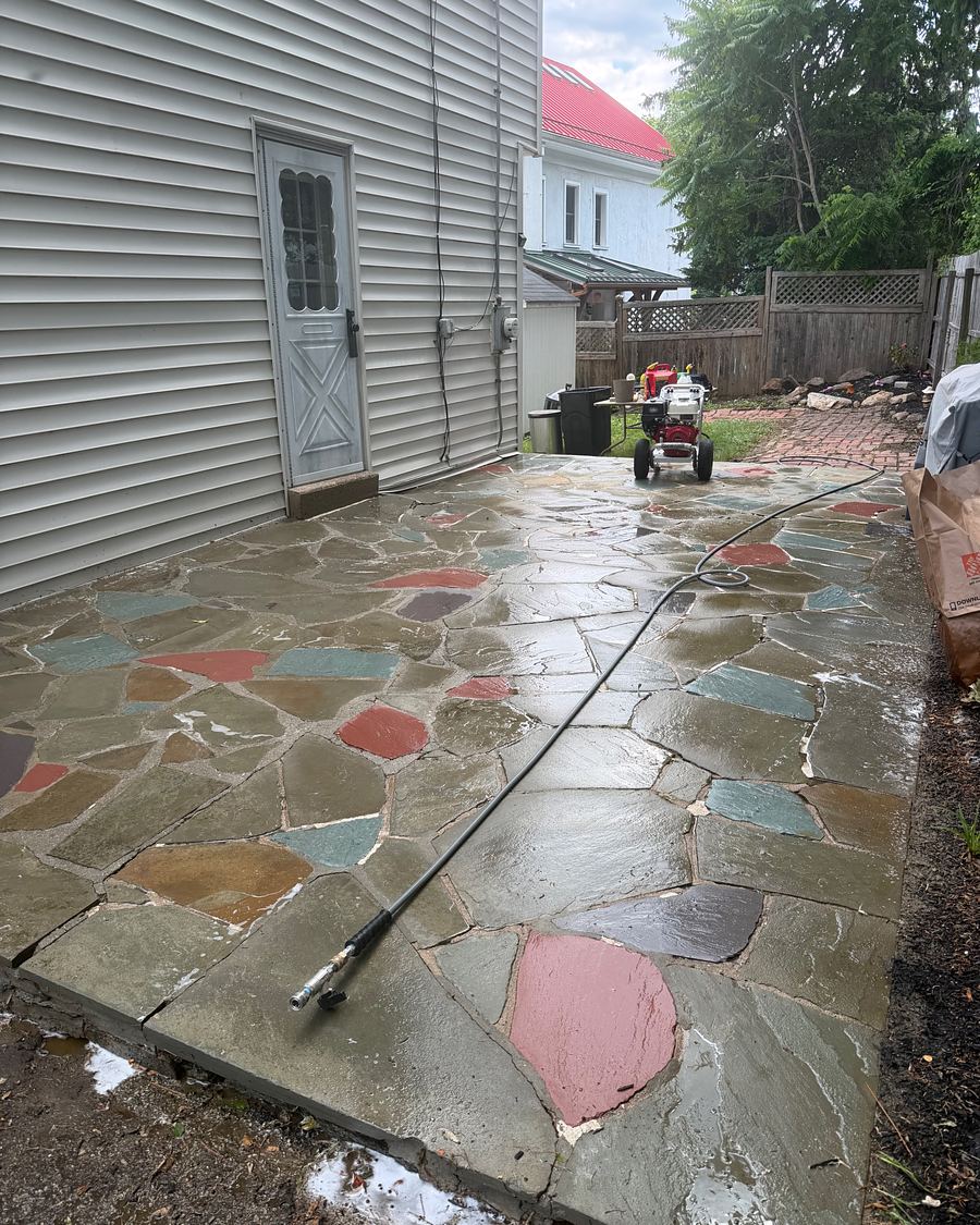Multicolored flagstone patio after washing, the red, teal and slate stones showing their real colors