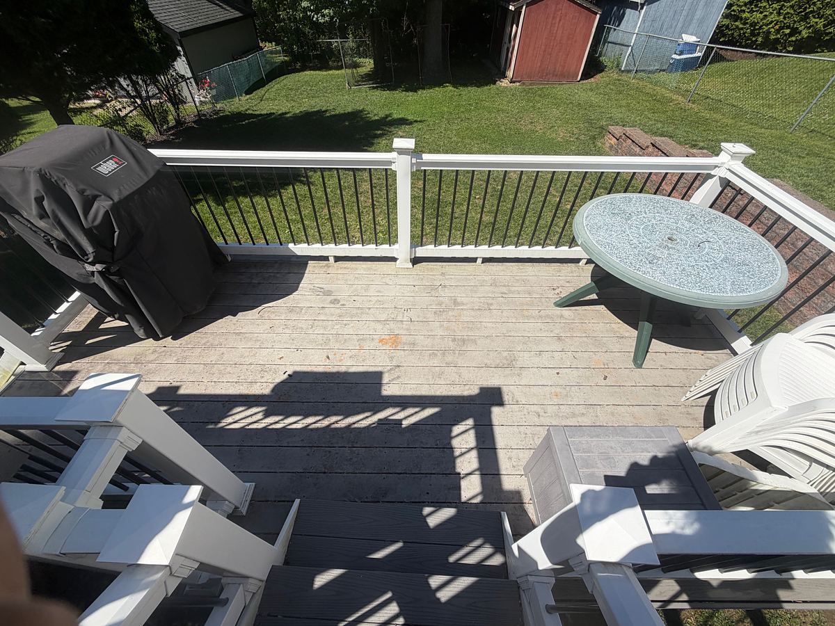 Composite deck in Havertown, PA before washing, the boards gray, weathered and stained