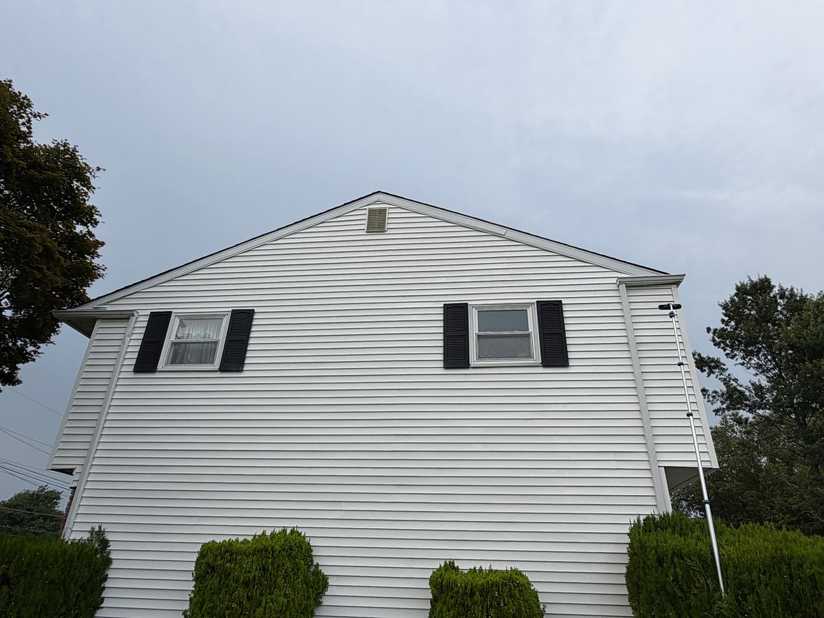 Washed white siding on the gable end of a Hatboro, PA home, clean from ground to peak