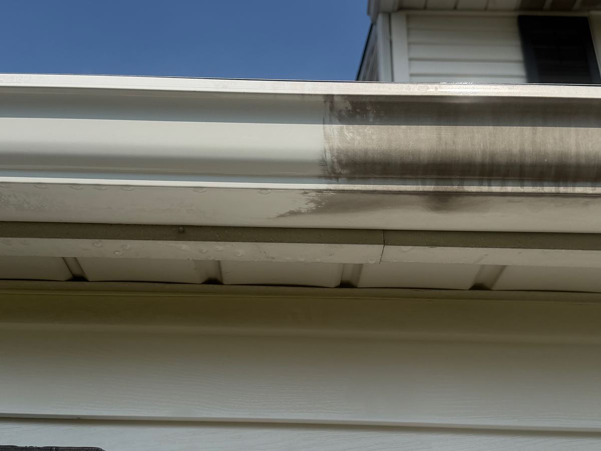 The same Hatboro, PA gutter partway through gutter brightening, bright white on the left and still streaked on the right