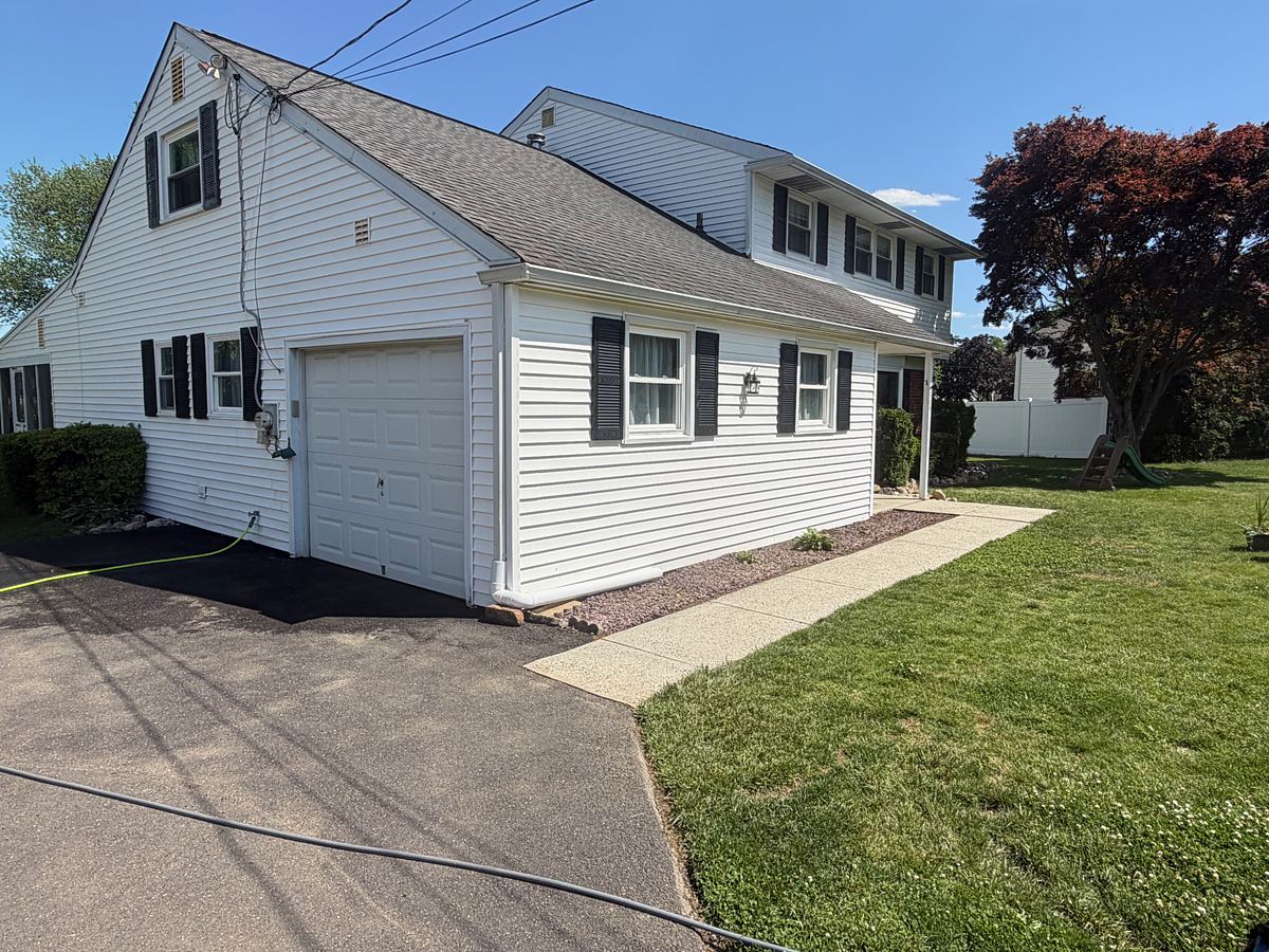 The Hatboro, PA concrete walkway and driveway after washing, an even light gray