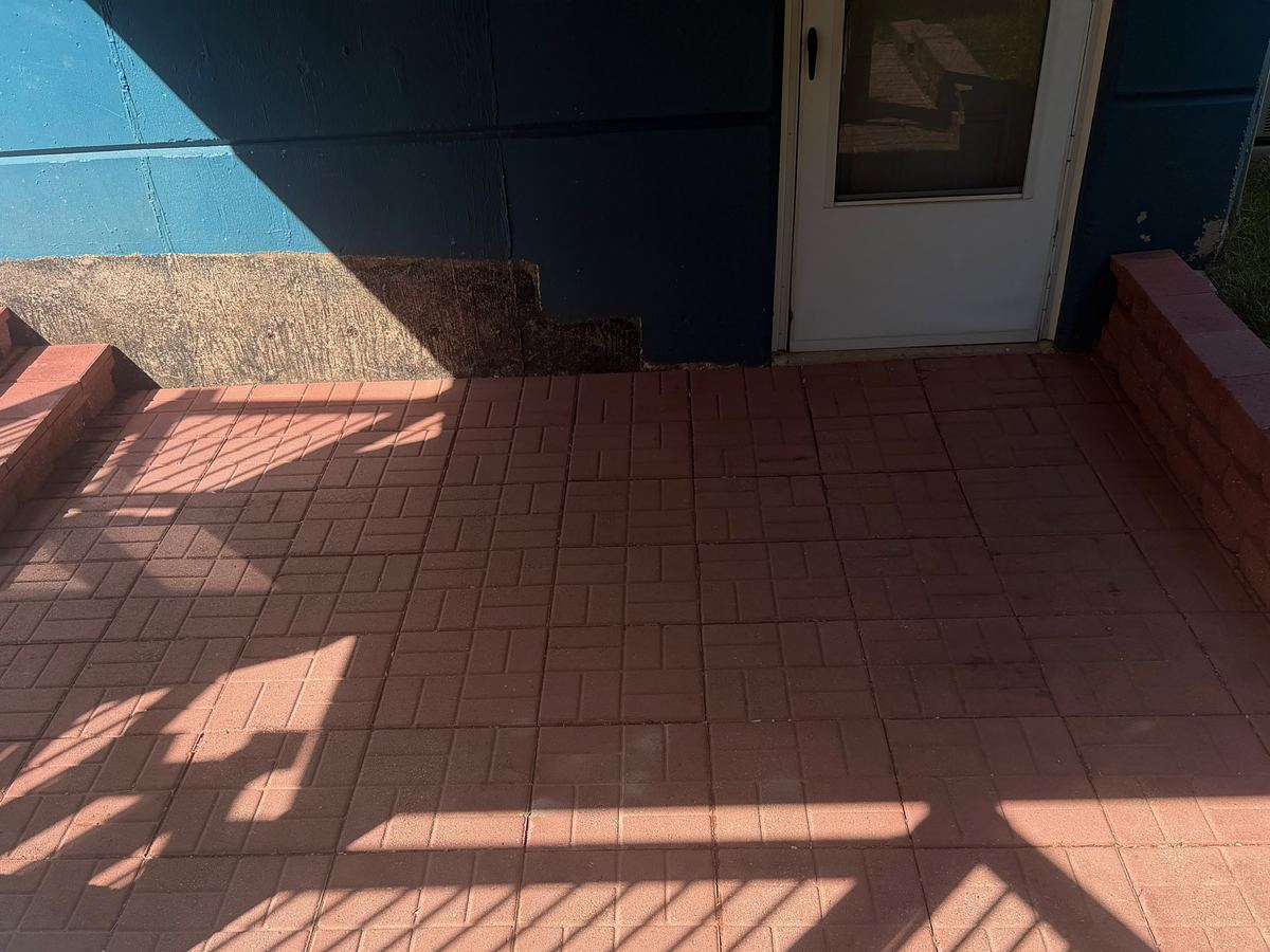Red brick paver patio in Havertown, PA after pressure washing, the brick bright and the joints clear